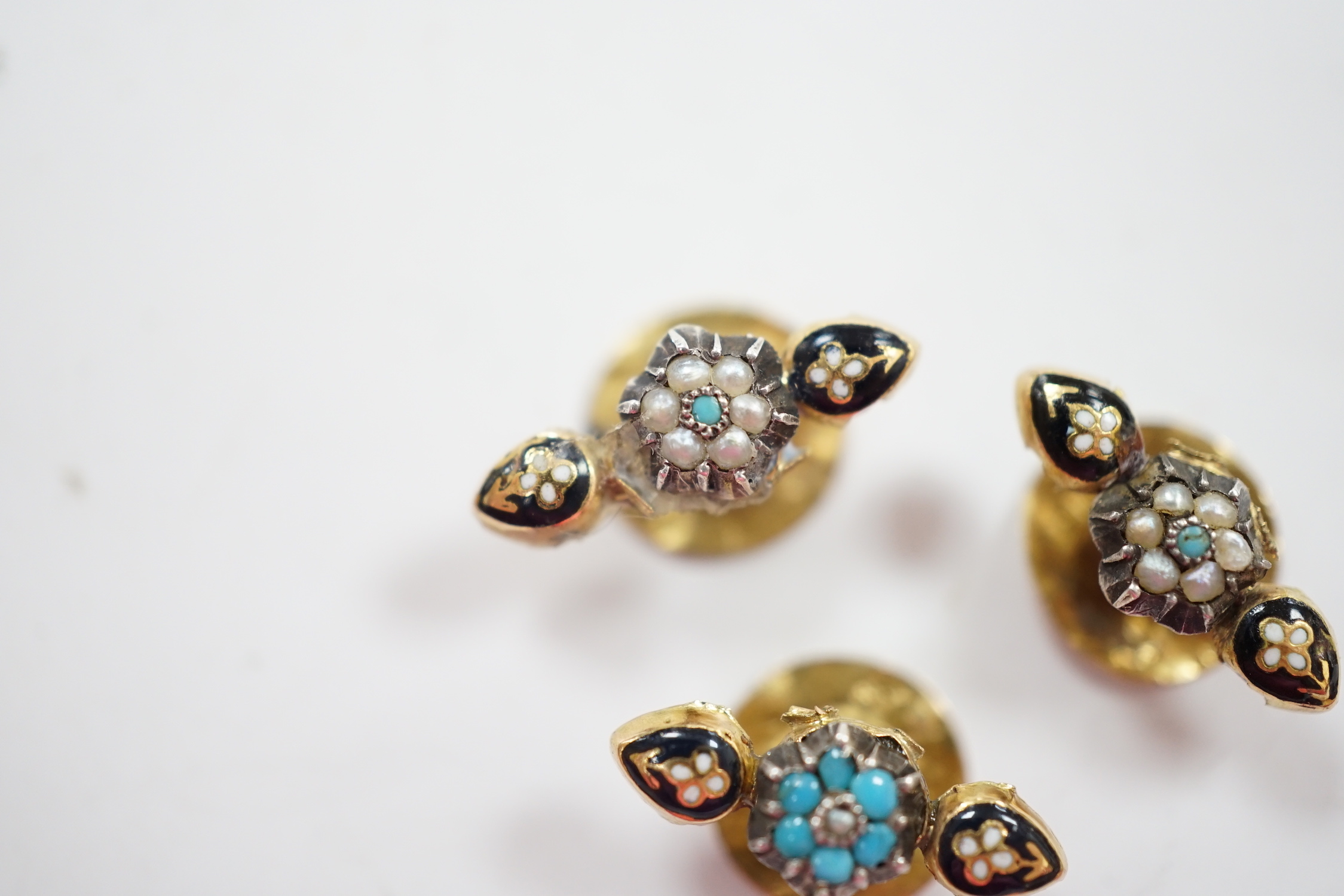 A small pair of antique yellow metal, two colour enamel, turquoise and seed pearl dress studs, 15mm and one other similar dress stud, gross weight 1.4 grams.